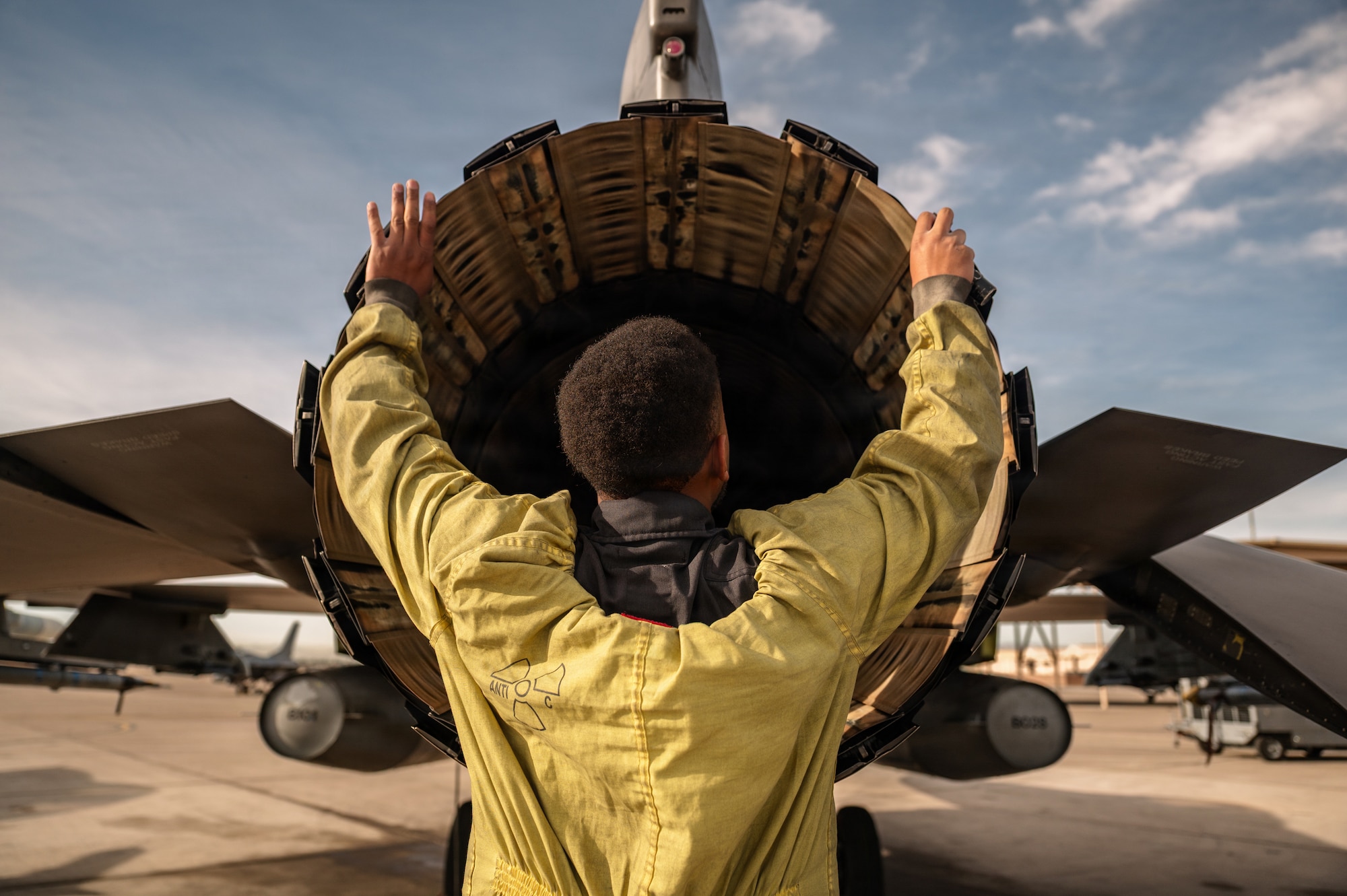 a person inspects a jet