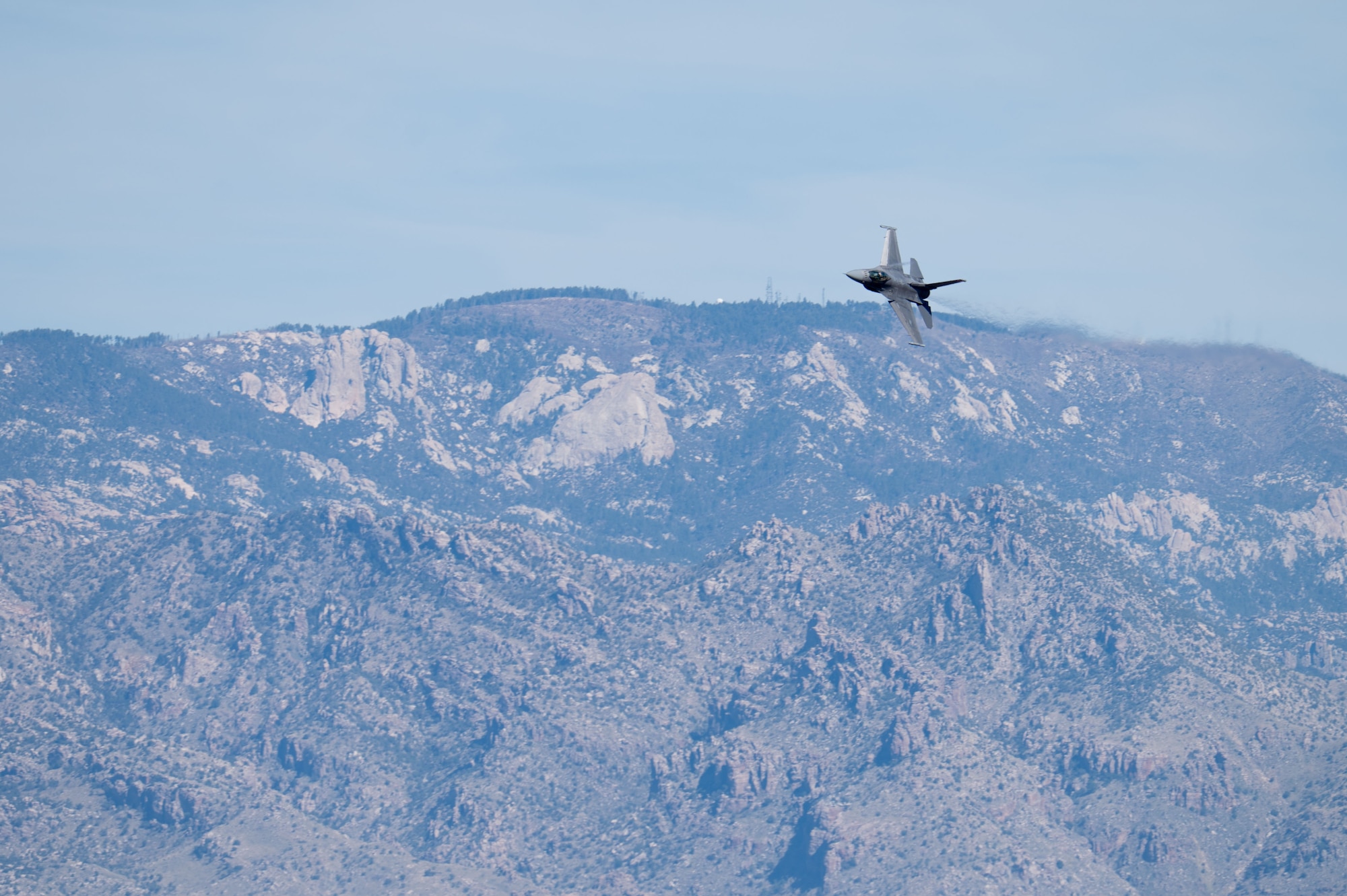 U.S. Air Force Maj. Taylor “FEMA” Heister, F-16 Demonstration Team pilot and commander, performs an aerial maneuver in an F-16 Fighting Falcon aircraft during the Heritage Flight Training Course at Davis-Monthan Air Force Base, Arizona, Feb. 28, 2026. The 2026 HFTC included the F-16, F-22 and F-35 demonstration teams, alongside the Air Force Heritage Flight Foundation pilots in historic aircraft. (U.S. Air Force Photo by Airman 1st Class Jaden Kidd)