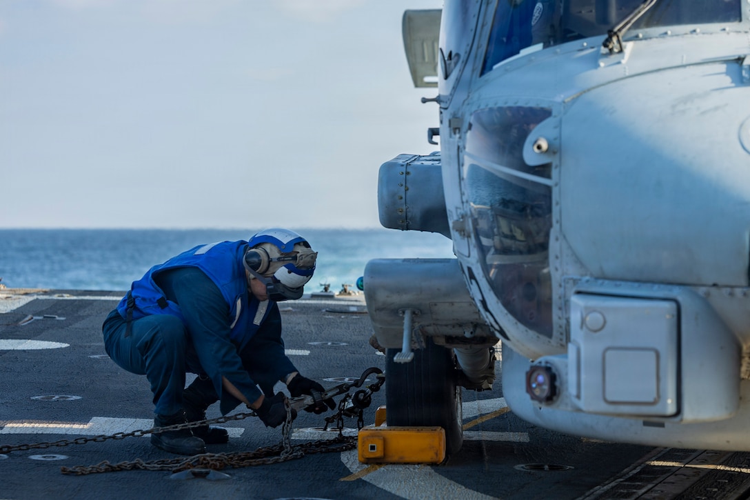 U.S. Sailor, assigned to Arleigh Burke-class guided-missile destroyer USS Delbert D. Black (DDG 119), removes chock and chain on an MH-60R Sea Hawk helicopter, attached to Helicopter Maritime Strike Squadron (HSM) 46 during a flight quarter evolution, in the U.S. Central Command area of responsibility in support of Operation Epic Fury, Mar. 4, 2026. (U.S. Navy photo)