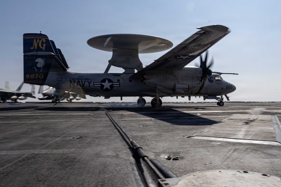 An E-2D Hawkeye, attached to Airborne Command & Control Squadron (VAW) 117, makes an arrested landing on the flight deck of Nimitz-class aircraft carrier USS Abraham Lincoln (CVN 72) in support of Operation Epic Fury, March 4, 2026. (U.S. Navy photo)