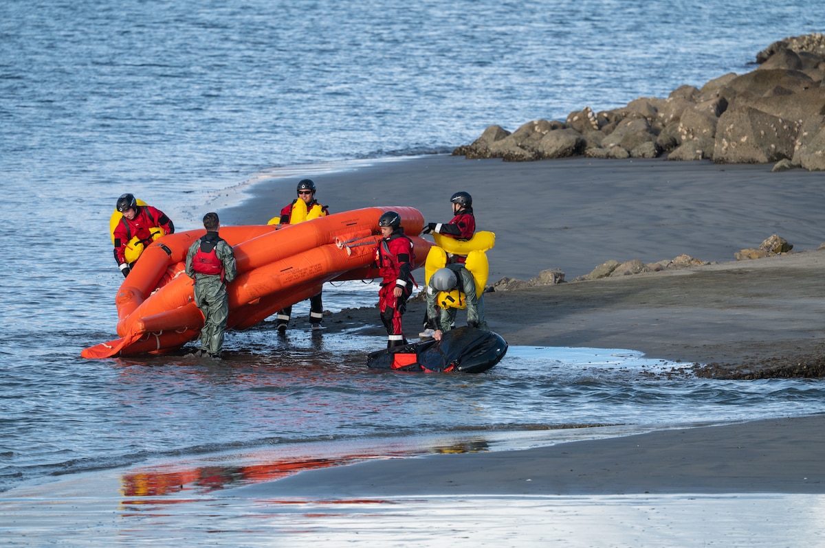 U.S. Airmen bring their raft to shore following open-water survival, evasion, resistance and escape training during Exercise Red Flag-Rescue 26-1 at San Diego, California, Feb. 17, 2026. Participants were challenged to think critically and creatively, showcasing their ability to adapt and innovate in the face of dynamic operational demands. (U.S. Air Force photo by Senior Airman Jasmyne Bridgers-Matos)