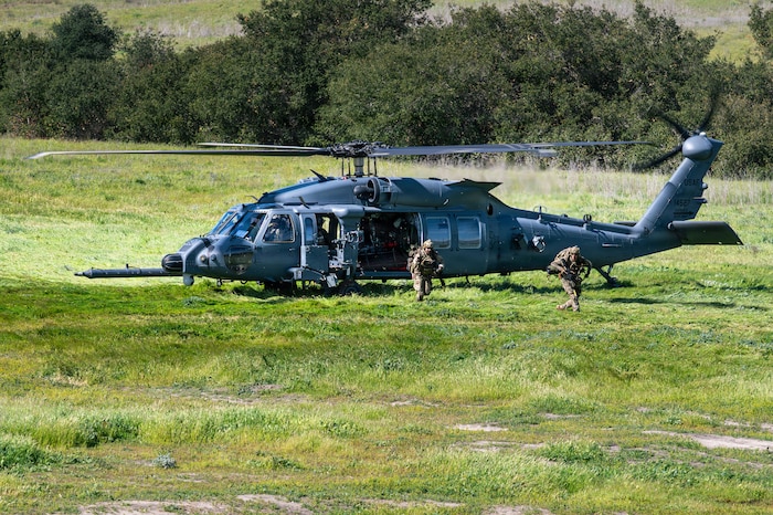 U.S. Air Force pararescuemen assigned to the 48th Rescue Squadron arrive at the scene of a simulated mass casualty in an HH-60W Jolly Green II helicopter during Exercise Red Flag-Rescue 26-1 at Marine Corps Base Camp Pendleton, California, Feb. 20, 2026. The exercise tests participants’ ability to execute Agile Combat Employment with precision, deploying follow-on forces and adapting to rapidly evolving threats while maintaining operational tempo. (U.S. Air Force photo by Senior Airman Jasmyne Bridgers-Matos)