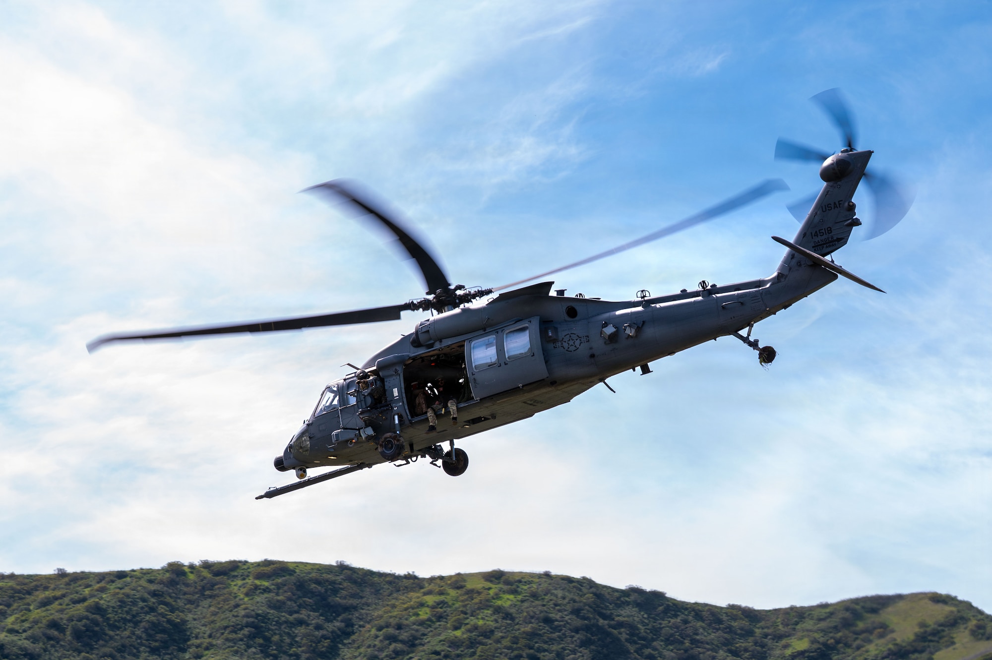 U.S. Airmen assigned to the 48th Rescue Squadron depart the scene of a simulated mass casualty in an HH-60W Jolly Green II helicopter during Exercise Red Flag-Rescue 26-1 at Marine Corps Base Camp Pendleton, California, Feb. 20, 2026. By simulating high-end threats, the exercise challenges participants to refine their skills and adapt to dynamic scenarios, reinforcing their ability to sustain operations under pressure. (U.S. Air Force photo by Senior Airman Jasmyne Bridgers-Matos)
