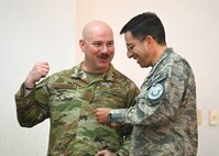 U.S. Air Force Capt. Jason Sanderson, left, Kentucky Air National Guard bilateral affairs officer, speaks with a Fuerza Aérea Ecuatoriana (FAE) military member during the U.S. and Ecuadorian Airman-to-Airman staff talks, at Davis-Monthan Air Force Base, Arizona, March 3, 2026. The talks focused on analyzing shared security cooperation goals—to plan and prioritize specific joint activities that enhance partnerships and interoperability between the two air forces. (U.S. Air Force photo by Staff Sgt. Abbey Rieves)