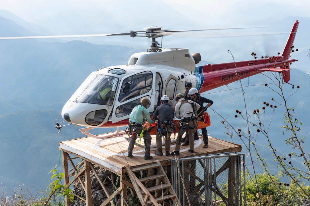 Defense POW/MIA Accounting Agency recovery team members load a simulated casualty onto a Lao Skyway Helicopter for a casualty evacuation rehearsal during a recovery mission in Laos, Jan. 28, 2026.