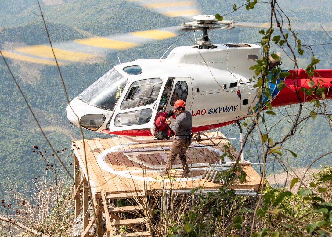 U.S. Army Capt. Conor McCabe, Defense POW/MIA Accounting Agency team leader, unloads gear from a Lao Skyway Helicopter during a recovery mission in Laos, Jan. 28, 2026.