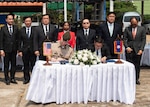 U.S. Army Lt. Col. Carl Hodgson, Laos Detachment 3 commander and Bounchanh Xayalath, director of MIA division, Europe-Americas Department, ministry of foreign affairs, sign transfer documents during a repatriation ceremony in Laos, Feb. 23, 2026.