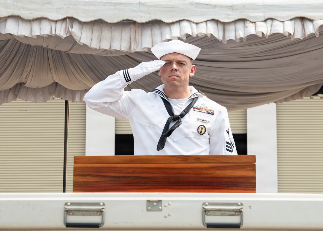 U.S. Navy Hospital Corpsman 1st Class Connor Dougherty, medic for the Defense POW/MIA Accounting Agency, salutes remains during a repatriation ceremony in Laos, Feb. 23, 2026.