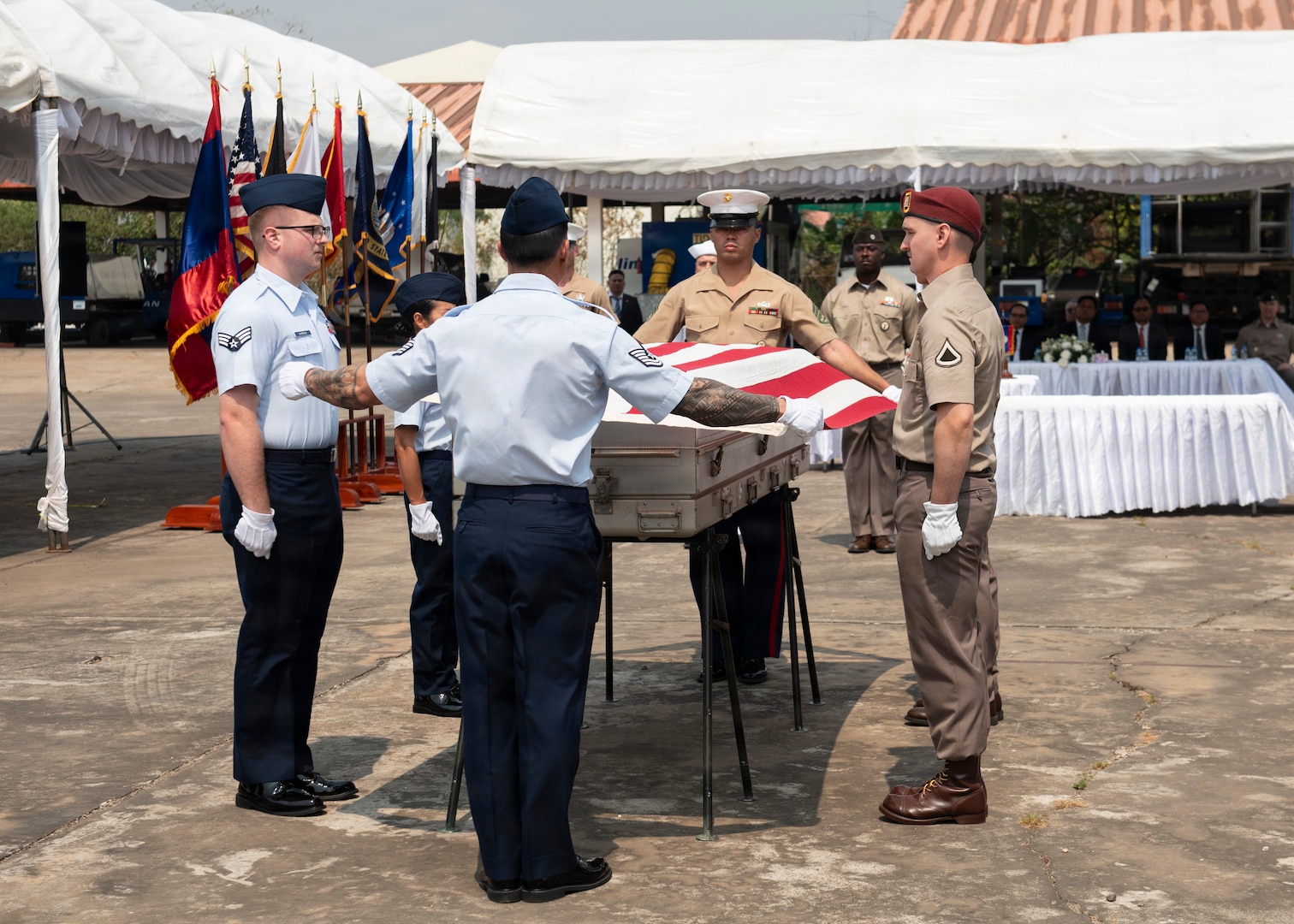 Members of 26-2LA Recovery Team for the Defense POW/MIA Accounting Agency place a flag over a casket during a repatriation ceremony in Laos, Feb. 23, 2026.