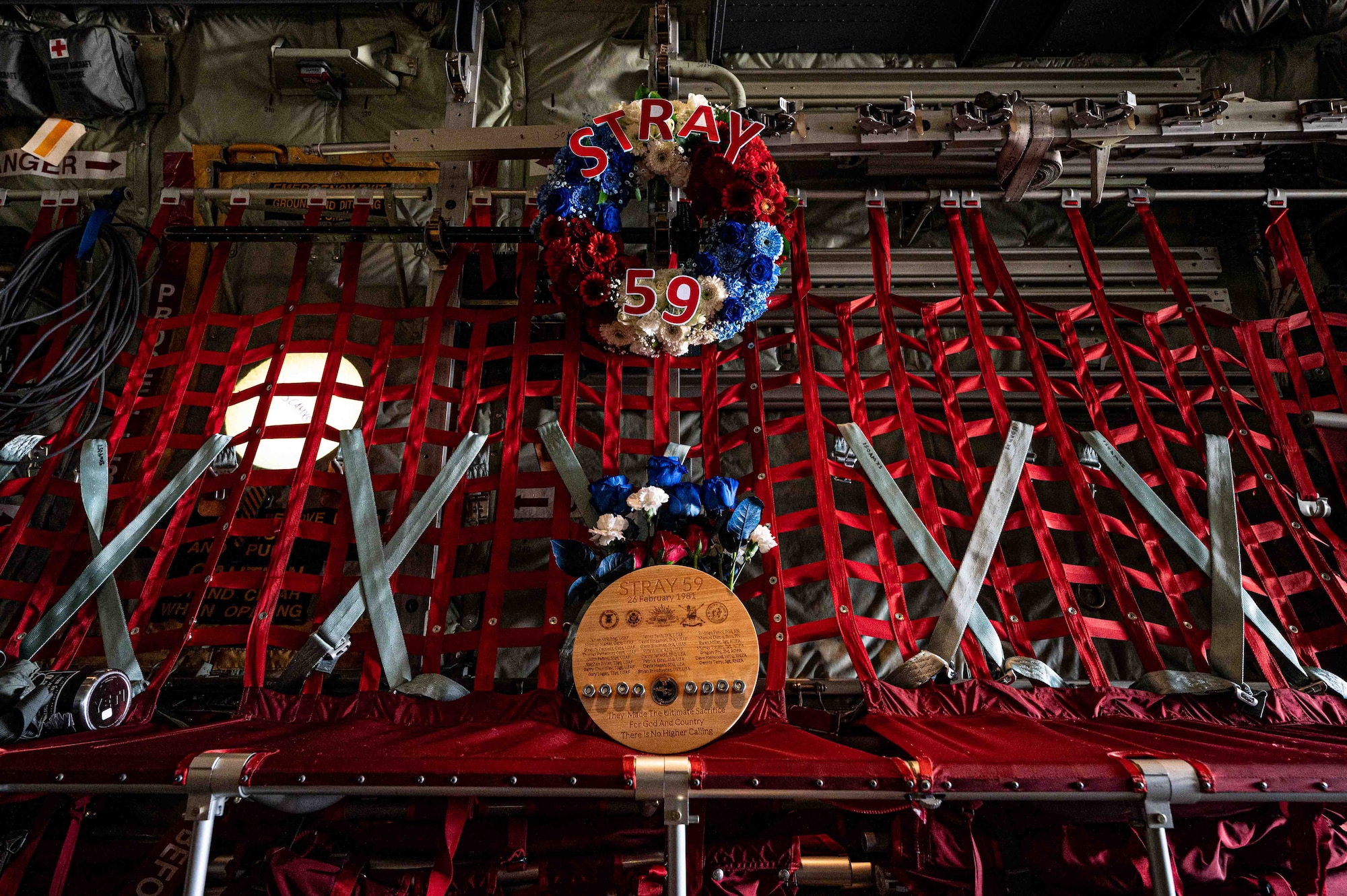 memorial plaque and wreath sit inside an aircraft on the seats.
