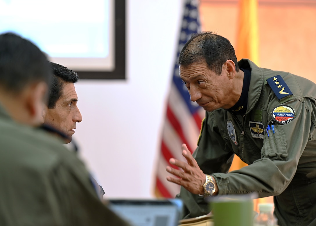 Fuerza Aérea Ecuatoriana (FAE) Col. José Guerrero Piñeiros, Air Forces Southern foreign liaison officer, speaks with fellow FAE members during the U.S. and Ecuadorian Airman-to-Airman staff talks, at Davis-Monthan Air Force Base, Arizona, March 3, 2026. The Airman-to-Airman talks discussed future joint training exercises, project collaborations and cultural exchanges to enhance the skills and understanding between the two partner nations. (U.S. Air Force photo by Staff Sgt. Abbey Rieves)