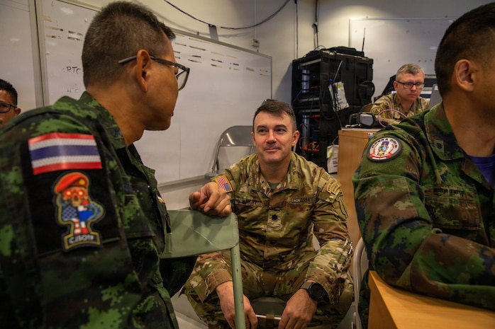 A U.S. Soldier engages in conversation with Royal Thai Armed Force members during the command post exercise (CPX) portion of Exercise Cobra Gold 2026 at Camp Red Horse, March 4, 2026