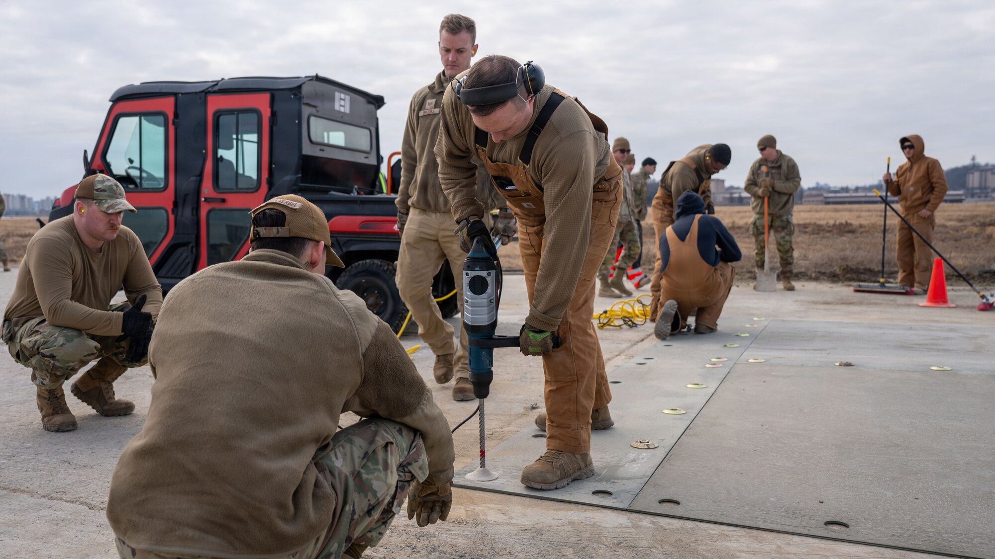 U.S. Air Force Airmen assigned to the 51st Civil Engineer Squadron drills concrete anchors during Rapid Osan Airfield Recovery training at Osan Air Base, Republic of Korea, Feb. 27, 2026. The fiber reinforced panels are used to quickly allow aircraft to takeoff in a contingency environment where the airfield may have been subject to damage. (U.S. Air Force photo by Senior Airman Rome Bowermaster)