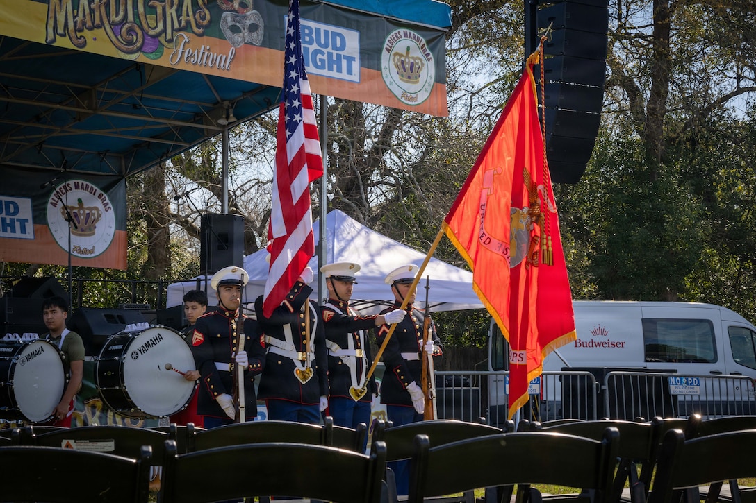 U.S. Marines with the Marine Forces Reserve color guard present the colors at the Algiers Mardi Gras Festival in New Orleans, Feb. 28, 2026. The display of colors holds deep significance, representing the Marine Corps’ enduring traditions of honor and pride, as well as their unwavering devotion to their country. (U.S. Marine Corps photo by Lance Cpl. Edward Spears)