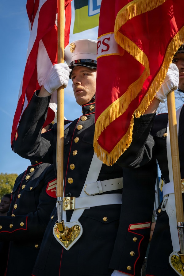 U.S. Marine Corps Cpl. Taylor Edmonds, training readiness non-commissioned officer, Force Headquarters Group, Marine Forces Reserve, carries the Marine Corps colors at the Algiers Mardi Gras Festival in New Orleans, Feb. 28, 2026. The display of colors holds deep significance, representing the Marine Corps’ enduring traditions of honor and pride, as well as their unwavering devotion to their country. (U.S. Marine Corps photo by Lance Cpl. Edward Spears)