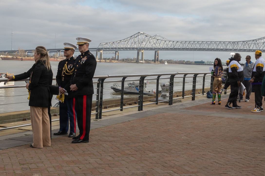 U.S. Marine Corps Maj. Gen. Douglas Clark, deputy commander of Marine Forces Reserve and Marine Forces South, right, his wife Mrs. Valerie Clark, left, and his aide 1stLt. Adam Franky, look out across the Mississippi River during Lundi Gras Festival at Woldenberg Park, Feb. 16, 2026. Maj. Gen. Clark celebrated Lundi Gras with the Zulu Social Aid and Pleasure Club, emphasizing the tradition and long-standing partnership built over the years. (U.S. Marine Corps photo by Sgt. Emily De La Torre)