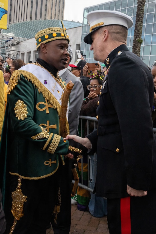 U.S. Marine Corps Maj. Gen. Douglas Clark, deputy commander of Marine Forces Reserve and Marine Forces South, greets the 2026 Zulu King, Dr. Ron Tassin, during Lundi Gras Festival at Woldenberg Park, New Orleans, Feb. 16, 2026. Maj. Gen. Clark celebrated Lundi Gras with the Zulu Social Aid and Pleasure Club, emphasizing the tradition and long-standing partnership built over the years. (U.S. Marine Corps photo by Sgt. Emily De La Torre)