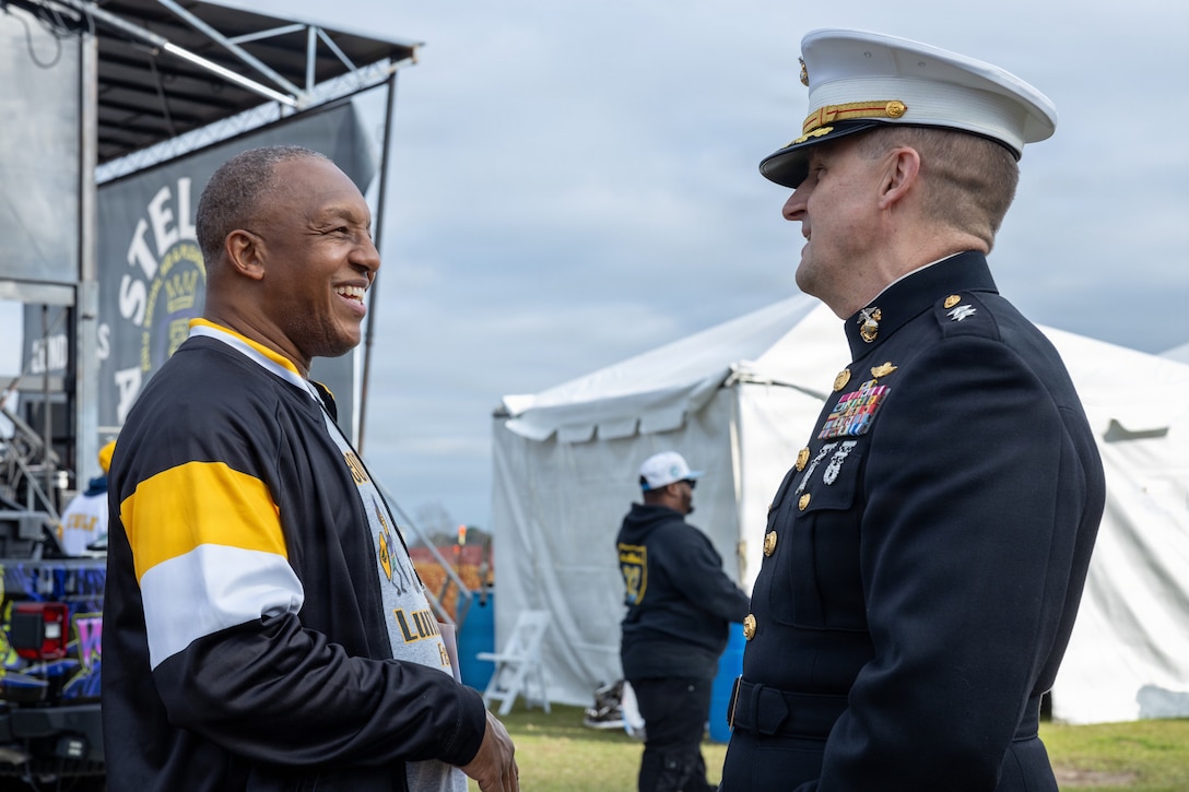 U.S. Marine Corps Maj. Gen. Douglas Clark, deputy commander of Marine Forces Reserve and Marine Forces South, speaks to a Zulu member during Lundi Gras Festival at Woldenberg Park, Feb. 16, 2026. Maj. Gen. Clark celebrated Lundi Gras with the Zulu Social Aid and Pleasure Club, emphasizing the tradition and long-standing partnership built over the years. (U.S. Marine Corps photo by Sgt. Emely Gonzalez)