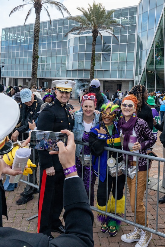 U.S. Marine Corps Maj. Gen. Douglas Clark, deputy commander of Marine Forces Reserve and Marine Forces South, poses for a photo with members of the crowd during Lundi Gras Festival at Woldenberg Park, New Orleans, Feb. 16, 2026. Maj. Gen. Clark celebrated Lundi Gras with the Zulu Social Aid and Pleasure Club, emphasizing the tradition and longstanding partnership built over the years. (U.S. Marine Corps photo by Sgt. Emely Gonzalez)