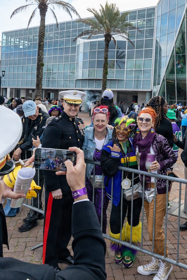 U.S. Marine Corps Maj. Gen. Douglas Clark, deputy commander of Marine Forces Reserve and Marine Forces South, poses for a photo with members of the crowd during Lundi Gras Festival at Woldenberg Park, New Orleans, Feb. 16, 2026. Maj. Gen. Clark celebrated Lundi Gras with the Zulu Social Aid and Pleasure Club, emphasizing the tradition and longstanding partnership built over the years. (U.S. Marine Corps photo by Sgt. Emely Gonzalez)