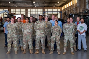Members of the 45th Vehicle Management Flight pose for a group photo inside the vehicle maintenance facility at Patrick Space Force Base, Florida, Feb. 20, 2026. The team maintains and repairs a diverse fleet of vehicles and specialized equipment, ensuring mission readiness across Space Launch Delta 45 and supporting operations both locally and abroad. (U.S. Space Force photo by Staff Sgt. Samuel Becker)