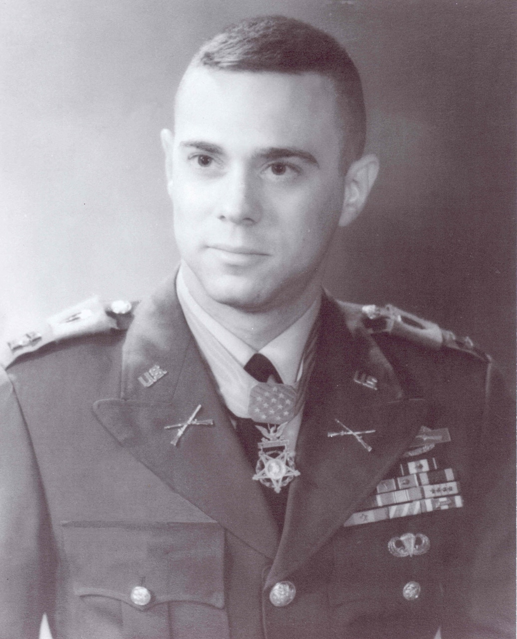 A man wearing a military dress uniform poses for a photo.