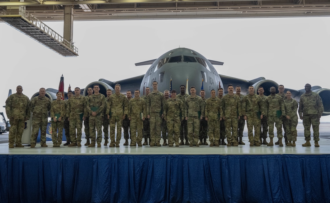 Members of Altus Air Force Base’s 97th Logistics Readiness Squadron (LRS), the 58th Airlift Squadron (AS) and 5-5 Air Defense Artillery Battalion (ADA), assigned to Fort Sill, pose for a group photo during a Joint Medals Ceremony at AFB, Oklahoma, March 4, 2026. The collaboration between the 58th AS, the 97th LRS and the 5-5 ADA demonstrates how Airmen and Soldiers are capable of operating seamlessly as a joint force, leveraging each other’s expertise to achieve shared objectives. (U.S. Air Force photo by Airman 1st Class Emma Wright)