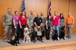 Brooke Army Medical Center’s facility dogs and their handlers pose for a group photo alongside BAMC commander, Col. Kevin Kelly, and Command Sgt. Major Jan “Eddy” Miller during a commissioning ceremony in BAMC’s Carolyn D. Putnam Auditorium, Joint Base San Antonio-Fort Sam Houston, Texas, Feb. 27, 2026. During the ceremony, BAMC’s newest facility dog, Phoenix, was commissioned to the rank of Warrant Officer One. Warrant Officer Phoenix is assigned to BAMC’s Soldier Recovery Unit, where his mission is to support recovering Soldiers with unwavering presence and steadfast loyaly. (DoW photo by Jason W. Edwards)