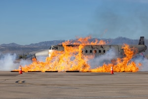 An aircraft trainer is engulfed in smoke and flames in preparation for a training exercise at Tucson International Airport, Tucson, Arizona, February 25, 2026. The Federal Aviation Administration requires regular training for emergency personnel at all airports to ensure crews have the ability to respond quickly and effectively to aircraft mishaps. (Photo by U.S. Air National Guard Tech. Sgt. Stephen Luke)