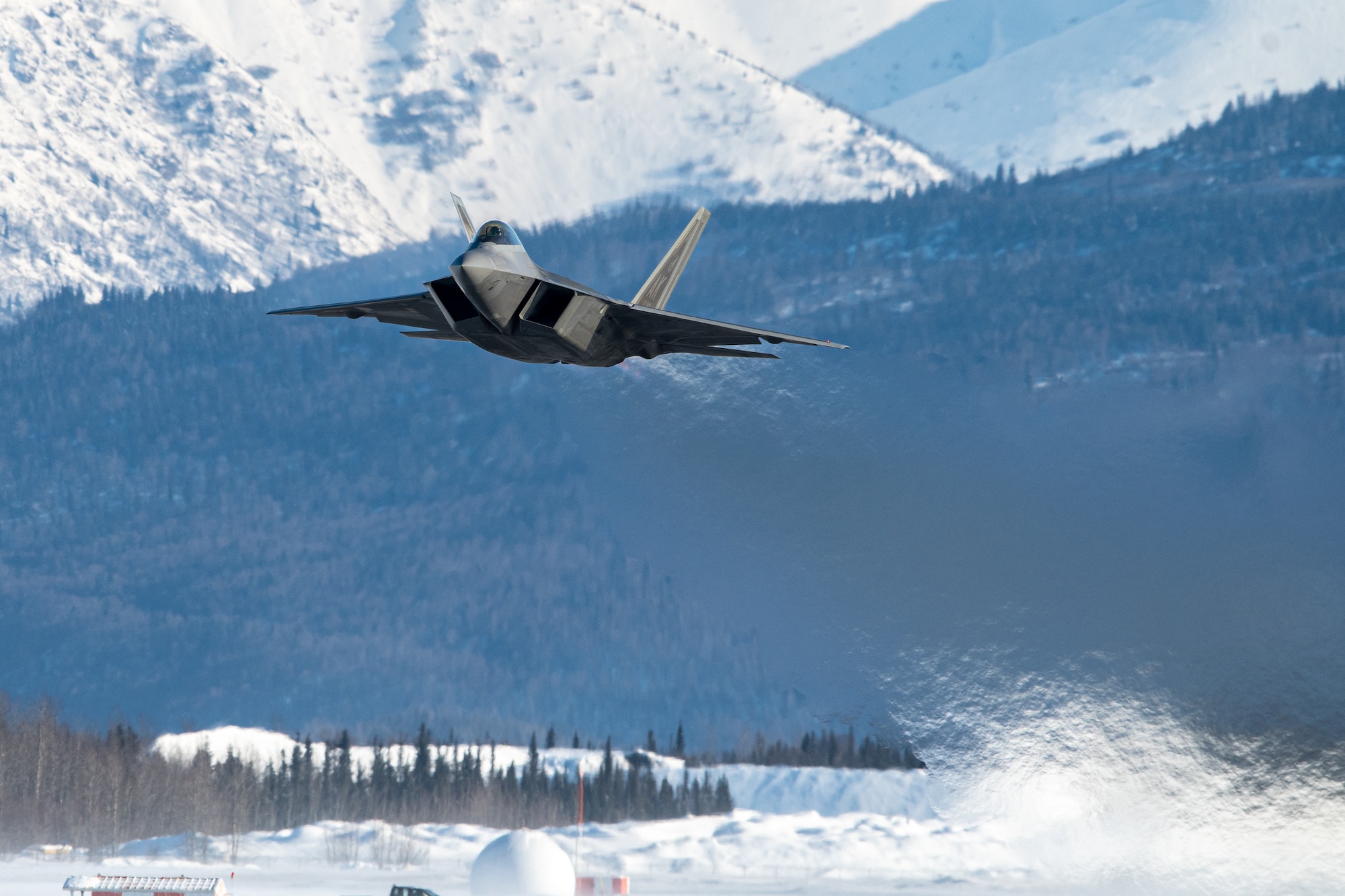 A U.S. Air Force F-22 Raptor aircraft assigned to the 3rd Wing takes off during a routine training sortie at Joint Base Elmendorf-Richardson, Alaska, Feb. 20, 2026. The F-22’s unique combination of stealth and maneuverability ensures that even in the vast, mountainous terrain of the Arctic, the U.S. maintains an uncontested advantage in the skies. (U.S. Air Force photo by Airman 1st Class Theodore Gowdy)