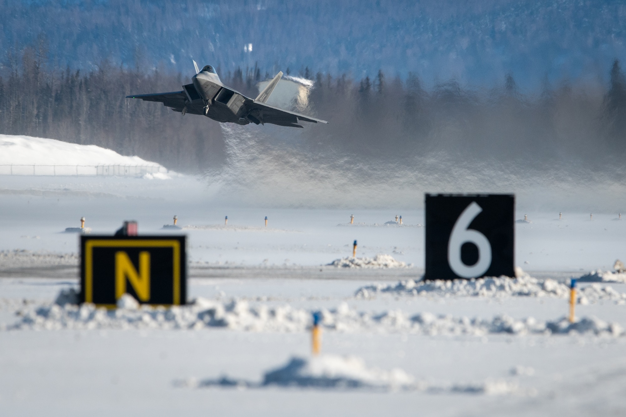 A U.S. Air Force F-22 Raptor aircraft assigned to the 3rd Wing takes off during a routine training sortie at Joint Base Elmendorf-Richardson, Alaska, Feb. 20, 2026. The F-22 Raptor is a key component of JBER’s position as a strategic power projection hub, where fifth-generation air superiority meets the world's most demanding operational environment. (U.S. Air Force photo by Airman 1st Class Theodore Gowdy)