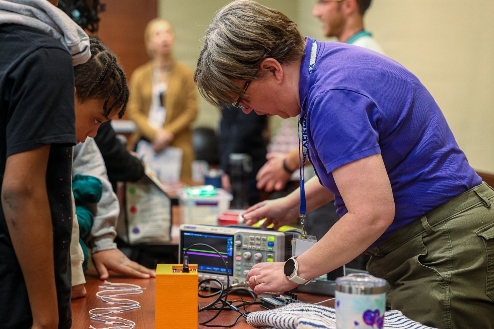 Naval Surface Warfare Center, Philadelphia Division (NSWCPD) mechanical engineer Nancy Agnew conducts a hands-on demonstration during the command’s National Engineers Week Science, Technology, Engineering and Mathematics (STEM) Outreach Day on Feb. 26, 2026, allowing students to observe control systems and wave mechanics principles in action. Throughout the day, engineers translated complex shipboard technologies into interactive experiments designed to connect classroom concepts with real-world fleet applications. (U.S. Navy Photo by Jay Butterbaugh, CTR)