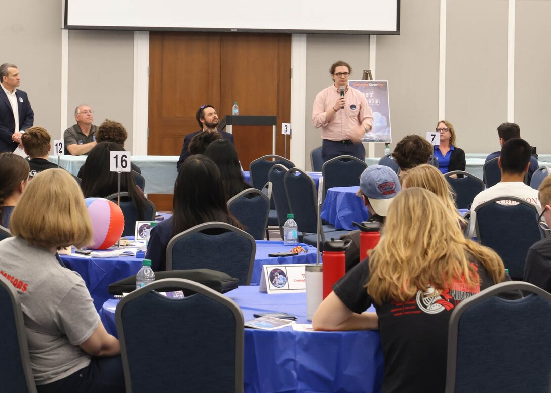 Camden Dean, a coastal engineer with the U.S. Army Corps of Engineers Jacksonville District, speaks with students from The Bolles School and Creekside High School during the 24th Annual Engineering Career Day Feb. 27, 2026, in Jacksonville, Florida. Dean discussed how coastal engineers design projects such as beach nourishment, navigation improvements and shoreline protection structures that strengthen coastal resilience. (U.S. Army Corps of Engineers photo by Public Affairs Specialist Misty Cunningham)