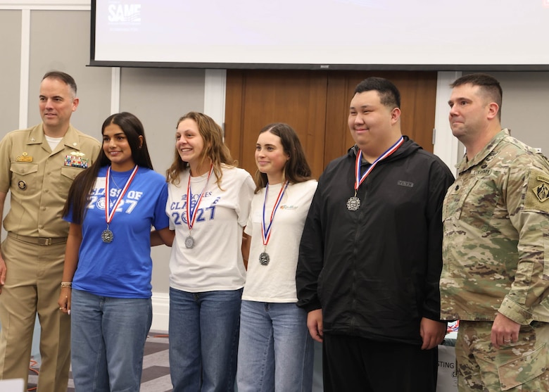 Students from The Bolles School and Creekside High School pose for a photo after receiving medals during the awards ceremony at the 24th Annual Engineering Career Day Feb. 27, 2026, in Jacksonville, Florida. Lt. Col. Matthew Westcott, deputy commander of the U.S. Army Corps of Engineers Jacksonville District, presented medals alongside U.S. Navy leadership recognizing student achievements in engineering design and teamwork. (U.S. Army Corps of Engineers photo by Public Affairs Specialist Misty Cunningham)