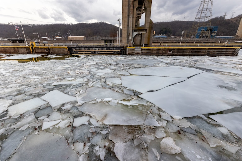 Ice on a river inside a lock chamber.