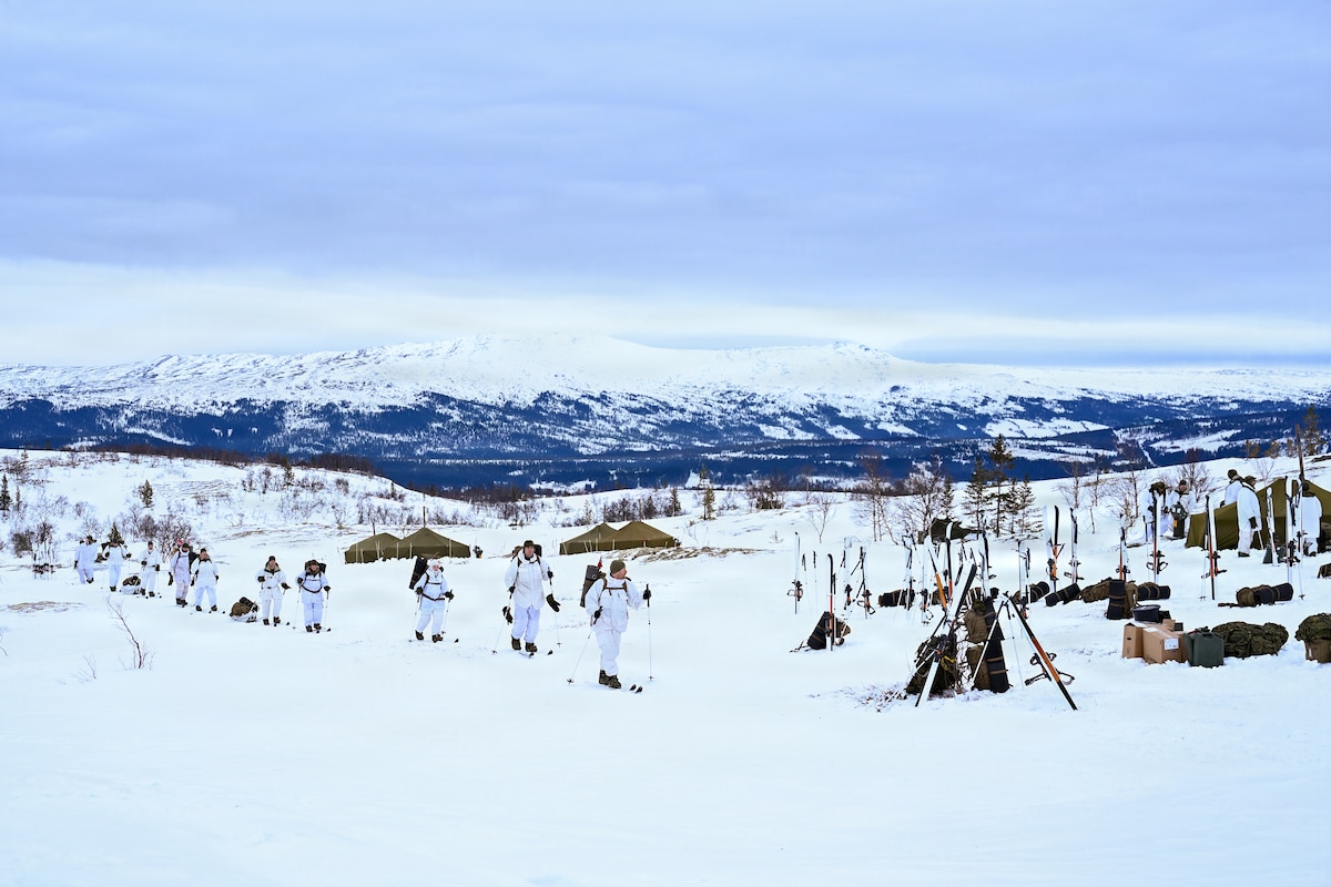 Soldiers and Airmen ski march up a mountain as part of NOREX.