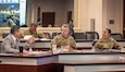 Don Nitti, AMCOM deputy to the commanding general, left, briefs Lt. Gen. Chris Mohan, AMC commanding general, and Maj. Gen. Lori Robinson, AMCOM commanding general, during the AMCOM major subordinate command update in the Sparkman Center on March 3.