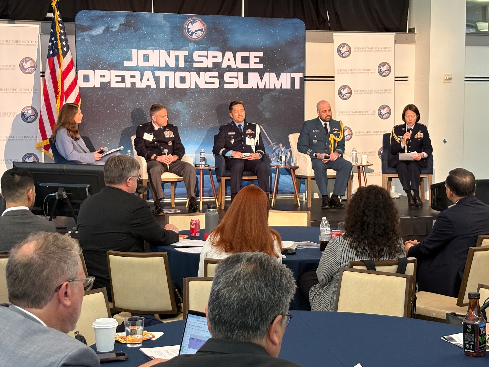 U.S. and foreign military leaders speak at a conference.