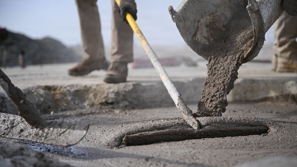 U.S. Air Force Airmen assigned to the 51st Civil Engineer Squadron move around freshly poured concrete during Rapid Osan Airfield Recovery training at Osan Air Base, Republic of Korea, Feb. 26, 2026. The Osan-developed recovery method prioritizes speed to achieve approximately 300 aircraft passes before transitioning to longer-term repair solutions. (U.S. Air Force photo by Senior Airman Rome Bowermaster)