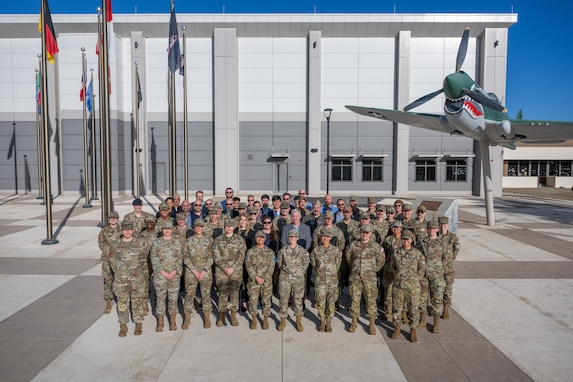 Military leaders and partners post for a group photo.
