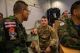 A U.S. Soldier engages in conversation with Royal Thai Armed Force members during the command post exercise (CPX) portion of Exercise Cobra Gold 2026 at Camp Red Horse, March 4, 2026