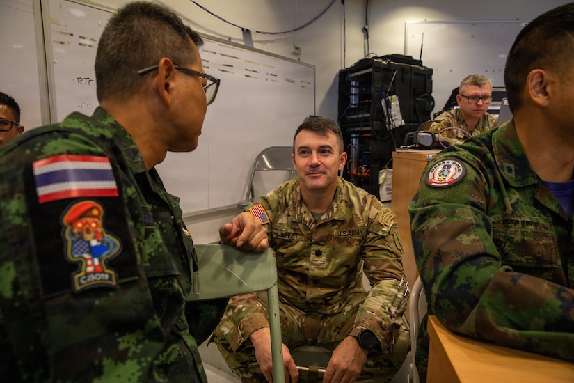 A U.S. Soldier engages in conversation with Royal Thai Armed Force members during the command post exercise (CPX) portion of Exercise Cobra Gold 2026 at Camp Red Horse, March 4, 2026