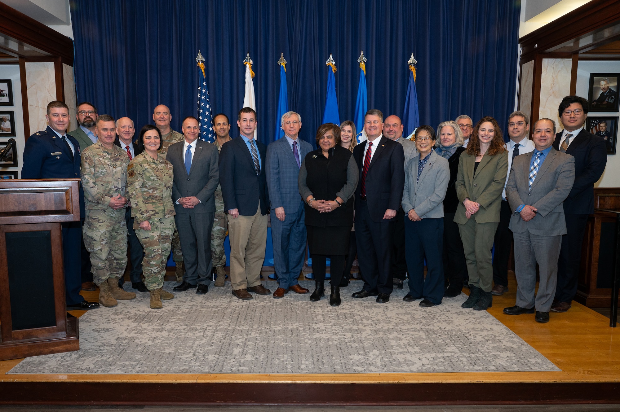 Image of group photo in front of flags.