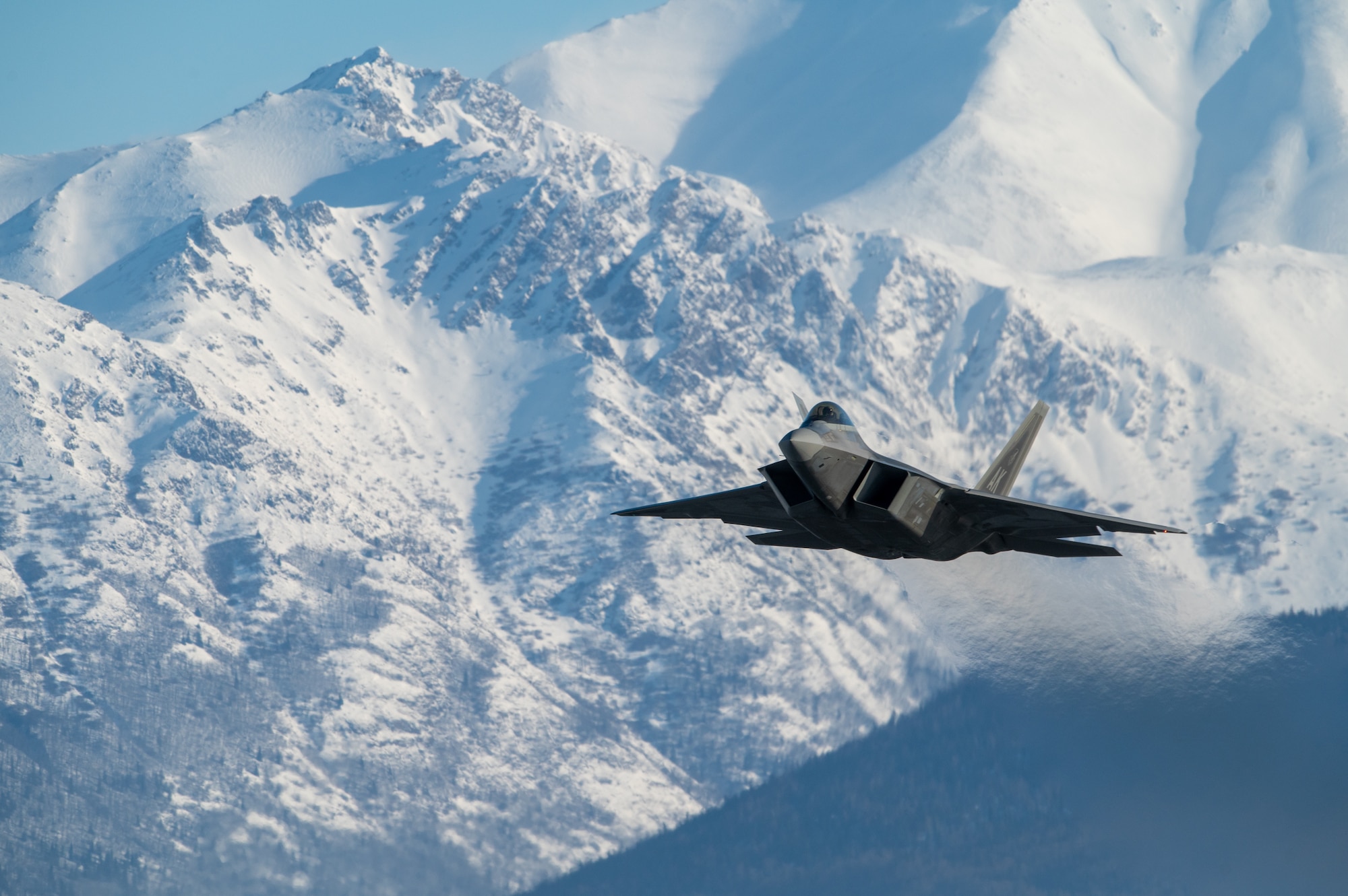 A U.S. Air Force F-22 Raptor aircraft assigned to the 3rd Wing takes off during a routine training sortie at Joint Base Elmendorf-Richardson, Alaska, Feb. 20, 2026. Unlike traditional fighters, the F-22 can sustain supersonic speeds without the use of fuel-consuming afterburners. This allows it to rapidly project air dominance across the vast distances of the Arctic theater to ensure homeland security. (U.S. Air Force photo by Airman 1st Class Theodore Gowdy)