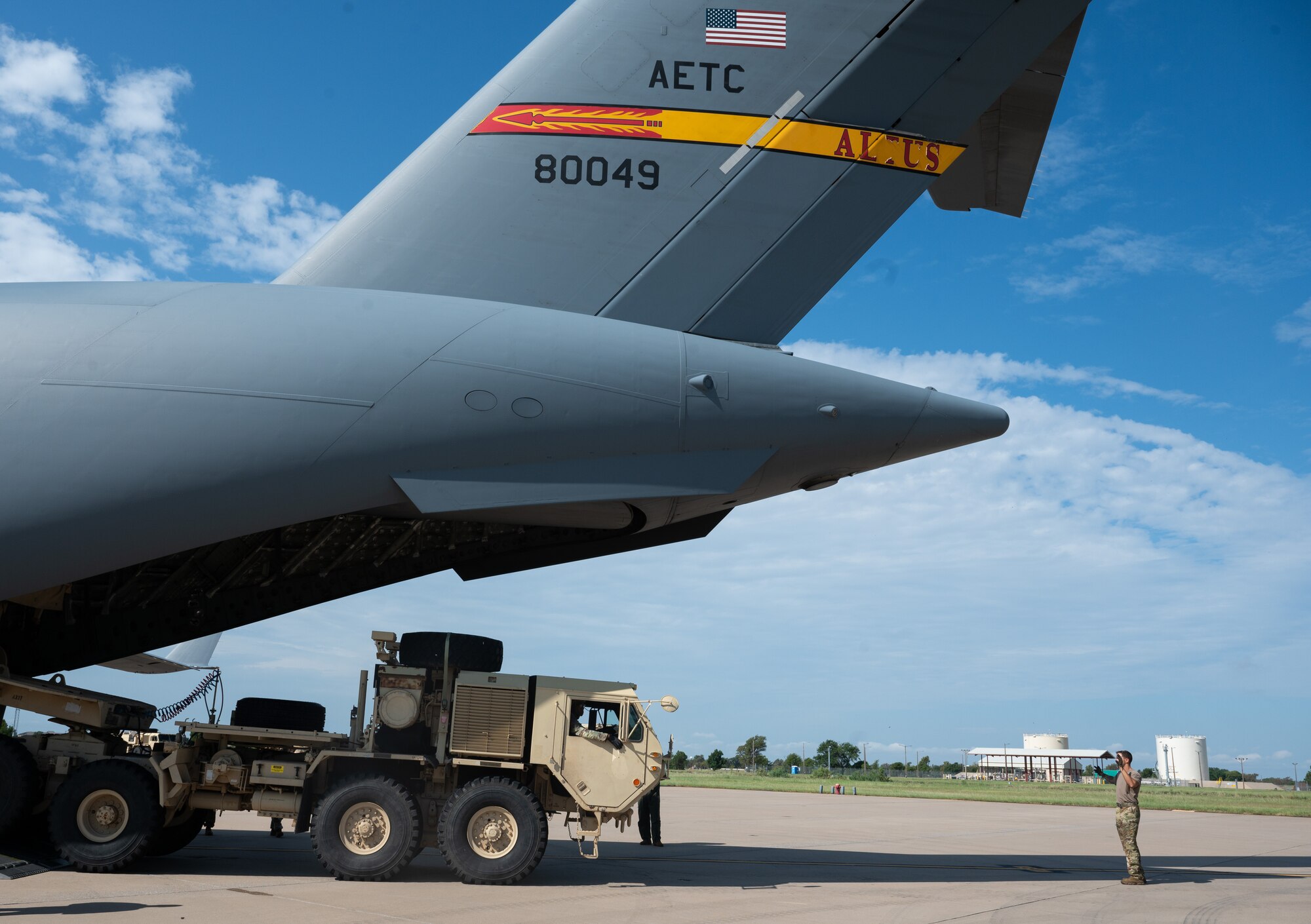 Staff Sgt. Dakota Maynor, 58th Airlift Squadron loadmaster, marshals a U.S. Army vehicle onto a C-17 Globemaster III aircraft during a training event at Altus Air Force Base, Okla., Aug. 20, 2025. The Airmen of Altus have been training with Soldiers from Fort Sill since at least 1999, offering decades of rapport, cohesiveness and increasing operational effectiveness. (U.S. Air Force photo by Tech. Sgt. Hailey Haux)