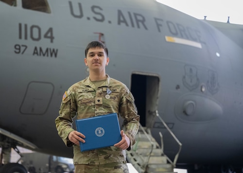U.S. Army Spc. Denahi Muina, a wheeled vehicle mechanic, assigned to the 5-5 Air Defense Artillery Battalion, displays his Air and Space Achievement Medal at Altus Air Force Base, Oklahoma, March 4, 2026. The ceremony honored interservice cooperation that continues to develop combat-capable forces ready to deploy at a moment’s notice. (U.S. Air Force photo by Airman 1st Class Emma Wright)