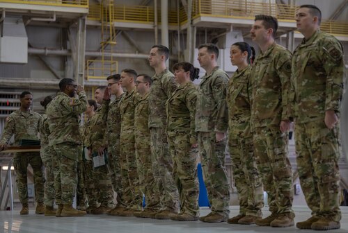 U.S. Army Lt Col. Dewayne Deener, commanding officer of the 5-5 Air Defense Artillery Battalion, pins medals on members of the 97th Logistics Readiness Squadron and 58th Airlift Squadron during a Joint Medals Ceremony at Altus Air Force Base, Oklahoma, March 4, 2026. During the ceremony, members of the 58th Airlift Squadron and the 97th Logistics Readiness Squadron were awarded the Army Achievement Medal in recognition of their support to Army training requirements. (U.S. Air Force photo by Airman 1st Class Emma Wright)