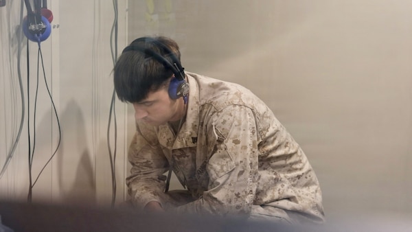 TWENTYNINE PALMS, Calif. (March 2, 2026) — Marine Corps Cpl. Volodymyr Shynkov undergoes an audiometric hearing test inside a soundproof audiometric booth at the Adult Medical Care Clinic aboard Marine Corps Air Ground Combat Center Twentynine Palms, March 2, 2026. The screening supports hearing conservation efforts that help ensure service members remain medically ready for operational missions. (U.S. Navy photo by Christopher Jones, NMRTC Twentynine Palms public affairs officer)
