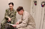 TWENTYNINE PALMS, Calif. (March 2, 2026) — Hospital Corpsman 3rd Class Jared Angapak, left, reviews the results of an audiogram with Marine Corps Lance Cpl. Carson Groom at the Adult Medical Care Clinic aboard Marine Corps Air Ground Combat Center Twentynine Palms, March 2, 2026. The screening supports hearing conservation efforts that help ensure service members remain medically ready for operational missions. (U.S. Navy photo by Christopher Jones, NMRTC Twentynine Palms public affairs officer)