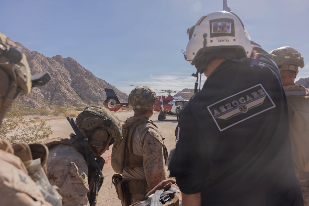 U.S. Marines and Sailors with 1st Combat Engineer Battalion, 1st Marine Division, assigned to Joint Task Force-Southern Border (JTF-SB), transport a simulated causality to an Airbus H130 helicopter during a medical evacuation training exercise with AeroCare Medical Transport in Yuma, Ariz., Feb. 7, 2026.  Joint training ensures that JTF-SB personnel are prepared to work with AeroCare Medical Transport teams if a medical emergency occurs in remote area along the southern border. U.S. Northern Command is working side-by-side with the Department of Homeland Security and the U.S. Customs and Border Protection within narrowly defined authorities to provide unique military capabilities to protect the territorial integrity of the U.S. southern border. (U.S. Marine Corps photo by Lance Cpl. Stella Tedesco)